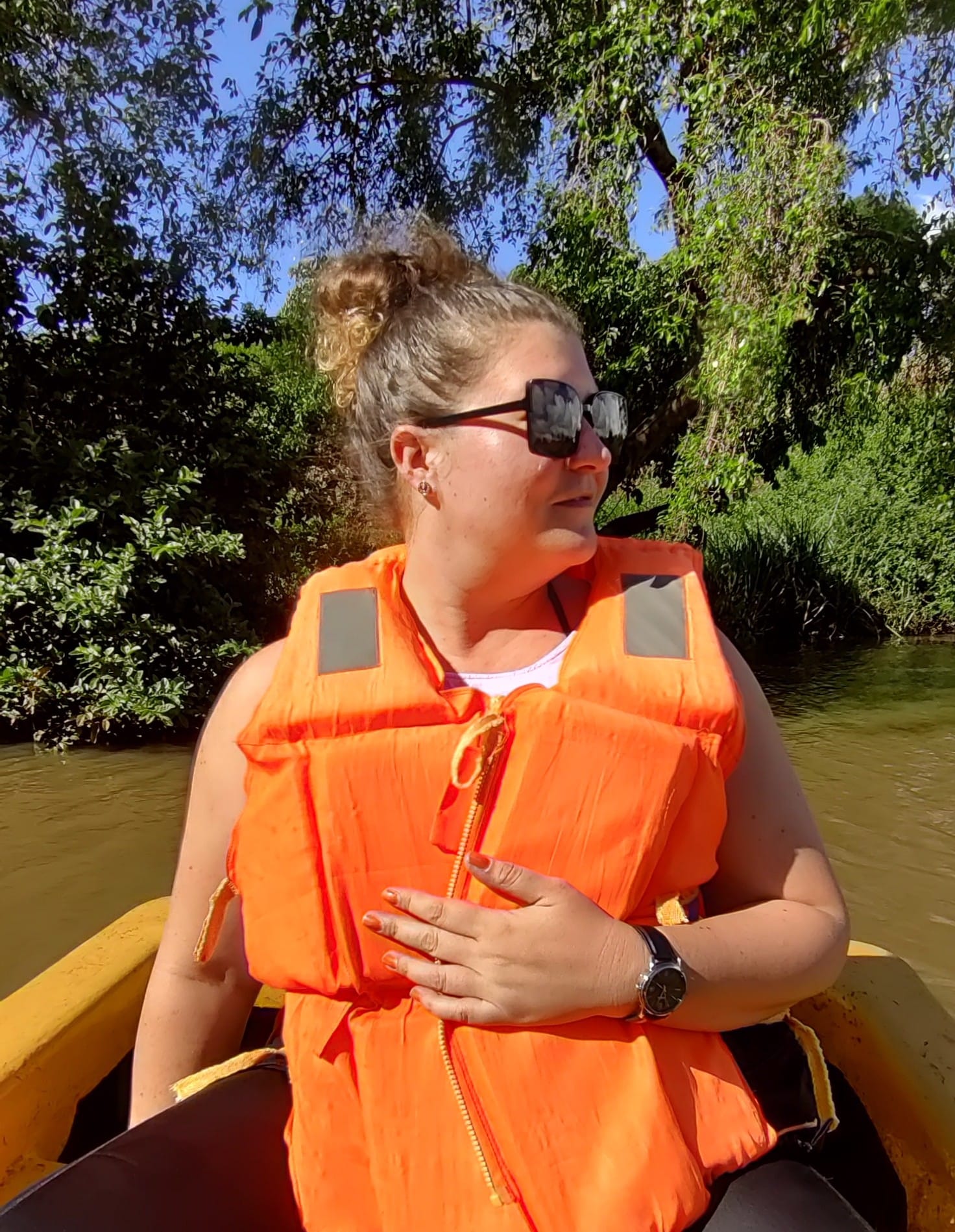 A person sitting in a paddle boat at Paradise Lost, wearing a life vest. Kiambu County, Kenya.
